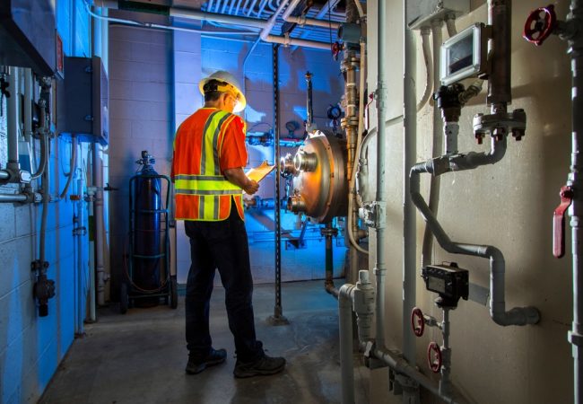 Wide,Shot,Of,Industrial,Scene,Lit,Blue,With,Pipes,,guages